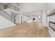 Open-concept living room with high ceilings, hardwood flooring, and a view of the kitchen and fireplace at 7685 Homer Dr, Cumming, GA 30028