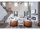 Spacious living room with a fireplace, large windows, and an open staircase leading to the second floor at 7685 Homer Dr, Cumming, GA 30028