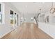 Spacious living area with a modern kitchen, opening to a large backyard through sliding glass doors at 7685 Homer Dr, Cumming, GA 30028