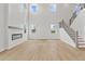 Bright living room with a modern fireplace, soaring ceilings, and large windows offering ample natural light at 7685 Homer Dr, Cumming, GA 30028