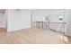 Open loft area with stylish railing and a view of the living space below with large windows at 7685 Homer Dr, Cumming, GA 30028