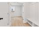Well-organized mudroom entrance with a bench and storage, leading into a sunlit room at 7685 Homer Dr, Cumming, GA 30028