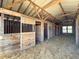 Interior view of a barn featuring wooden horse stalls at 3179 Meadow Trl, Loganville, GA 30052