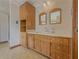 Bright bathroom featuring wood cabinets, a vanity, twin mirrors and plenty of storage at 3179 Meadow Trl, Loganville, GA 30052