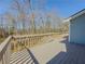 Spacious wooden deck with railing overlooking a wooded backyard at 3179 Meadow Trl, Loganville, GA 30052