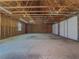 Spacious garage interior with concrete floor and exposed wood framing at 3179 Meadow Trl, Loganville, GA 30052