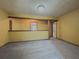 Open living room featuring gray carpet, yellow walls, and wood trim at 3179 Meadow Trl, Loganville, GA 30052