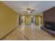 Sunlit living room with hardwood floors, ceiling fan, brick fireplace and multiple archways at 3179 Meadow Trl, Loganville, GA 30052