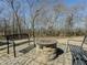 Outdoor patio with stone fire pit and metal benches at 3179 Meadow Trl, Loganville, GA 30052