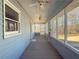 Enclosed front porch featuring light blue siding and a ceiling fan at 3179 Meadow Trl, Loganville, GA 30052