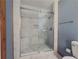 Contemporary shower with marble tile and glass door at 3179 Meadow Trl, Loganville, GA 30052