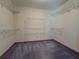 Walk-in closet with shelves, gray carpet and wood trim at 3179 Meadow Trl, Loganville, GA 30052