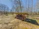 An outdoor wood storage structure filled with firewood under a bright blue sky at 3179 Meadow Trl, Loganville, GA 30052