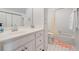 Bright bathroom with a white vanity, a mirror, and a shower and tub combo at 475 Highland Gate Cir, Suwanee, GA 30024