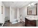 Bathroom with a shower-tub combo, vanity with mirror, and tile flooring for a functional design at 475 Highland Gate Cir, Suwanee, GA 30024