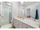 Well-lit bathroom with a vanity, a mirror, and a tub and shower combo at 475 Highland Gate Cir, Suwanee, GA 30024