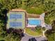 Overhead shot of a community pool and tennis courts surrounded by trees at 475 Highland Gate Cir, Suwanee, GA 30024