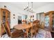 Formal dining room with hardwood floors, vintage furnishings, and elegant lighting at 475 Highland Gate Cir, Suwanee, GA 30024