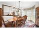 Dining room featuring hardwood floors, large mirror, and elegant decor at 475 Highland Gate Cir, Suwanee, GA 30024