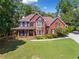 Traditional two-story home with a well-manicured lawn and inviting front porch at 475 Highland Gate Cir, Suwanee, GA 30024