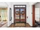 Welcoming foyer with hardwood floors and double doors, creating a grand entrance at 475 Highland Gate Cir, Suwanee, GA 30024