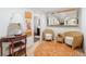 Hallway with decorative accents and seating, leading to a bathroom, offering a welcoming and stylish transition space at 475 Highland Gate Cir, Suwanee, GA 30024