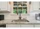 Kitchen sink with granite countertop and subway tile backsplash at 475 Highland Gate Cir, Suwanee, GA 30024