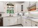 Bright kitchen with white cabinets, granite countertops, and stainless steel sink with subway backsplash at 475 Highland Gate Cir, Suwanee, GA 30024