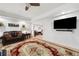 Inviting living room featuring a leather sofa, decorative rug, and mounted television for comfortable relaxation at 475 Highland Gate Cir, Suwanee, GA 30024