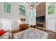 Bright living room with stone fireplace, piano, and large windows offering natural light at 475 Highland Gate Cir, Suwanee, GA 30024