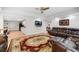 Open-concept living room with neutral decor and a large screen television at 475 Highland Gate Cir, Suwanee, GA 30024