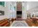 Inviting living room with a stone fireplace, large windows, and hardwood floors at 475 Highland Gate Cir, Suwanee, GA 30024