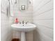 Bright powder room featuring shiplap walls, a pedestal sink, and stylish fixtures at 475 Highland Gate Cir, Suwanee, GA 30024