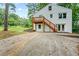 Two-story house with white painted brick, a wood deck, walk-out basement, and a concrete driveway at 1995 Venetian Sw Dr, Atlanta, GA 30311