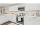 Kitchen featuring white cabinets, stainless steel appliances, and a white countertop at 1995 Venetian Sw Dr, Atlanta, GA 30311