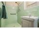 Bathroom shower with green tile and a small sink at 2436 Hazelwood Ne Dr, Atlanta, GA 30345