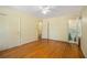 Bedroom featuring hardwood floors, a ceiling fan, and an ensuite bathroom at 2436 Hazelwood Ne Dr, Atlanta, GA 30345