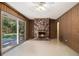 Cozy living room with a brick fireplace and sliding glass doors to the backyard at 2436 Hazelwood Ne Dr, Atlanta, GA 30345