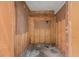 Unfinished storage area with wood paneling and mounted hooks for organization at 2436 Hazelwood Ne Dr, Atlanta, GA 30345