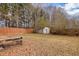 A grassy backyard with a storage shed and a fenced perimeter at 2800 Jona Trl, Dacula, GA 30019