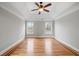 Spacious bedroom featuring decorative tray ceiling and rich hardwood floors at 2800 Jona Trl, Dacula, GA 30019