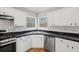 Clean kitchen featuring white cabinets, black countertops, and stainless steel appliances at 2800 Jona Trl, Dacula, GA 30019