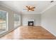 Bright living room with hardwood floors, fireplace, and large windows at 2800 Jona Trl, Dacula, GA 30019