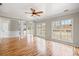 Bright living room featuring hardwood floors, large windows, and a ceiling fan at 2800 Jona Trl, Dacula, GA 30019