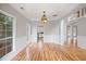 Sun-filled living room with hardwood floors, fresh paint, and a decorative chandelier fixture at 2800 Jona Trl, Dacula, GA 30019