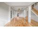 Bright living room with hardwood floors, white trim, and decorative columns at 2800 Jona Trl, Dacula, GA 30019