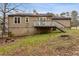 The backyard features a wooden deck with stairs, set against a backdrop of a green lawn at 4053 Overland Trl, Snellville, GA 30039