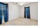 This bedroom features neutral walls, carpeted floors and blue curtains that let light filter in from the windows at 4053 Overland Trl, Snellville, GA 30039