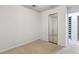 A bedroom with patterned wallpaper features a mirrored closet and a doorway to the rest of the house at 4053 Overland Trl, Snellville, GA 30039