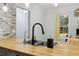 Bright kitchen featuring butcher block counters, stainless steel sink, modern faucet, and natural light at 4053 Overland Trl, Snellville, GA 30039